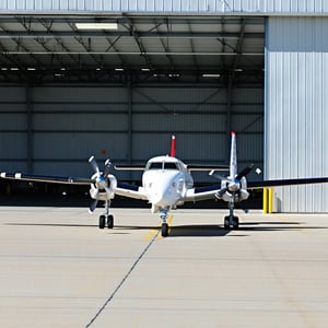 turbo prop aircraft leaving hanger